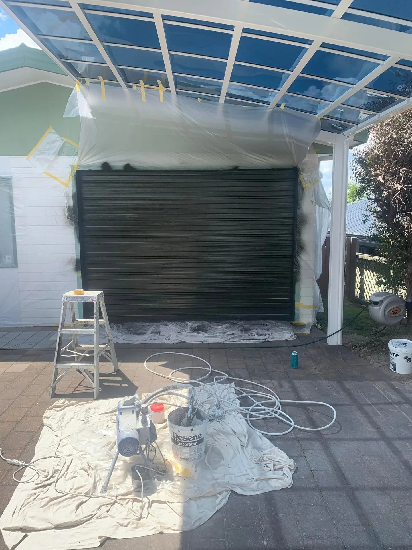 Garage door spray painting in progress